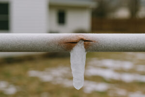 Cracked outdoor copper plumbing due to frost.