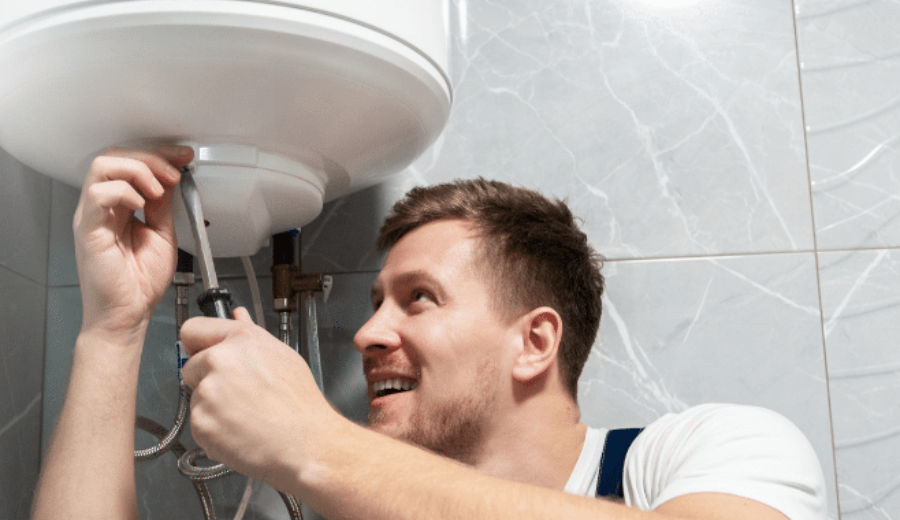 Plumber repairing a water heater.